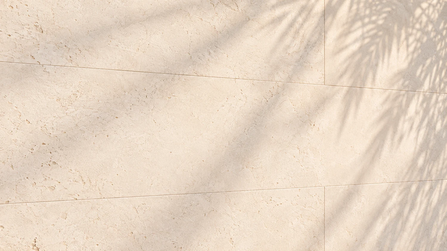 Palm shadows moving across warm limestone