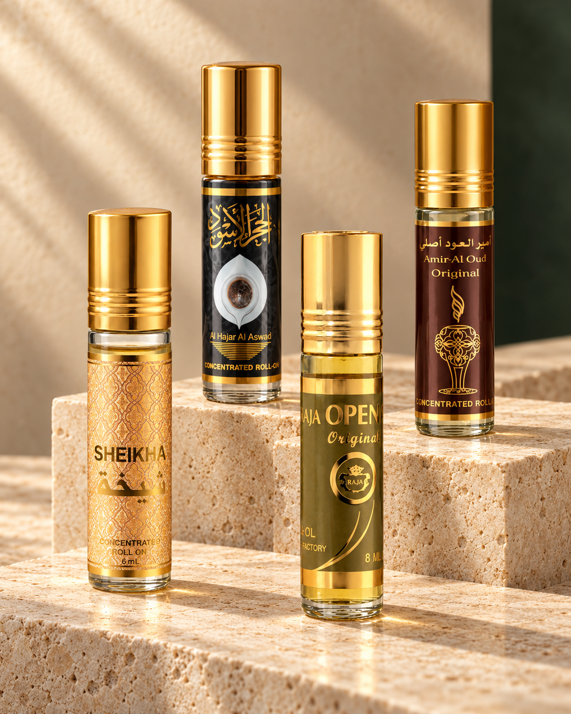 Four Qurban collection perfume oil roll-ons displayed on limestone plinths
